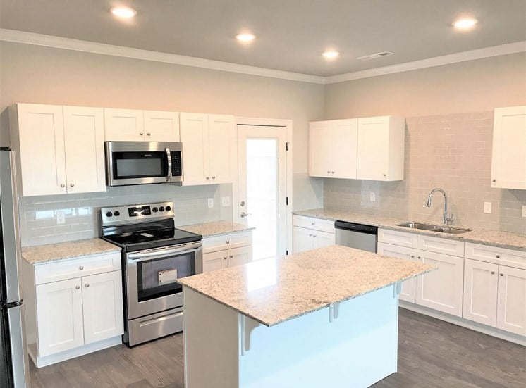 B3 (1-car) Kitchen with island, granite countertops, stainless steel appliances